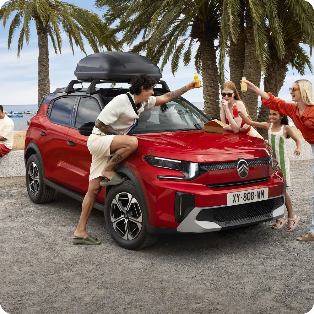Outdoor view of Citroën C3 Aircross SUV fitted with roof bars and roof box for versatile, spacious and affordable travel capability.