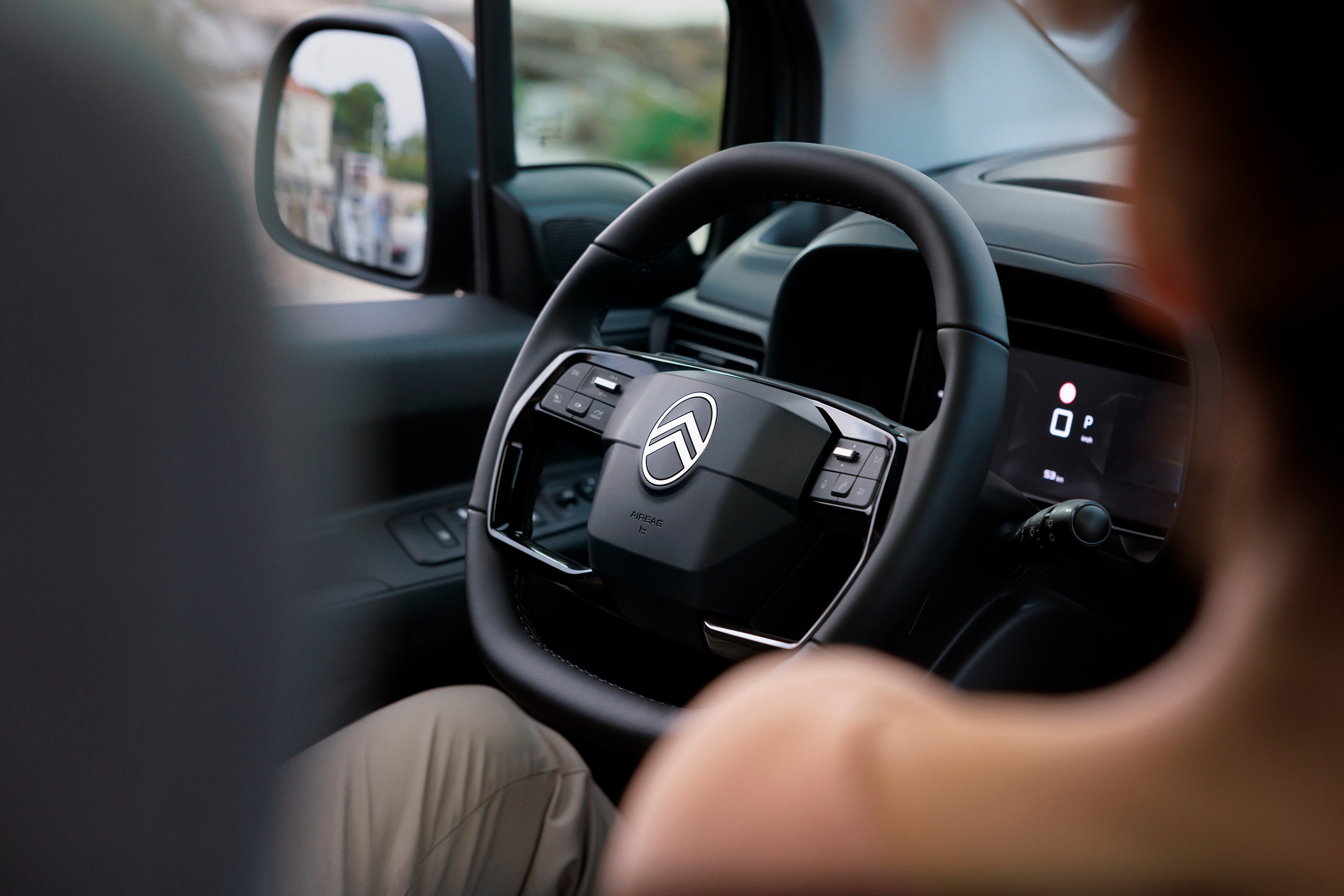 Driver‑view ë-Berlingo showing ergonomic steering wheel, comfort, safety, technology and smoother everyday driving experience